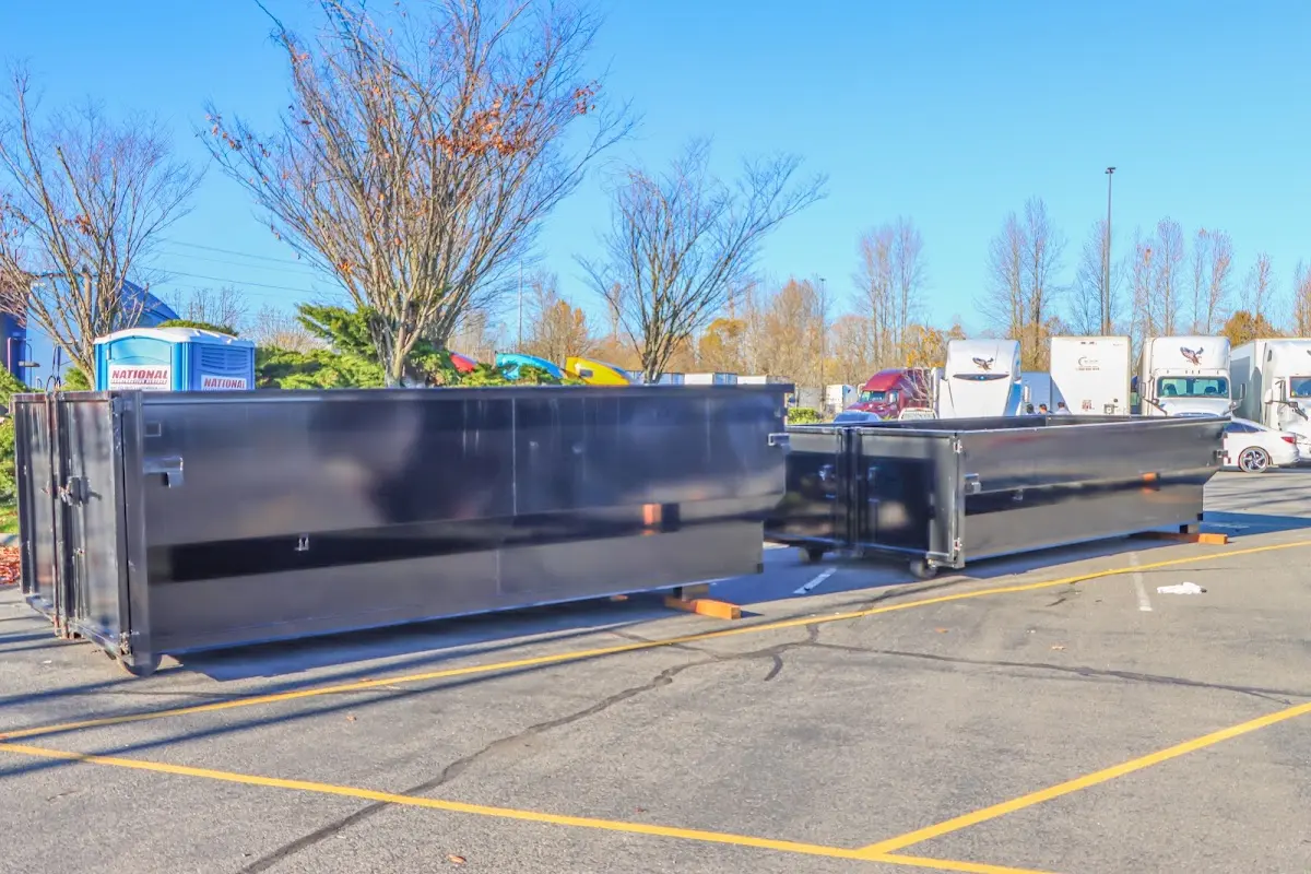 Professional dumpster rental service with roll-off container on residential driveway in Pine